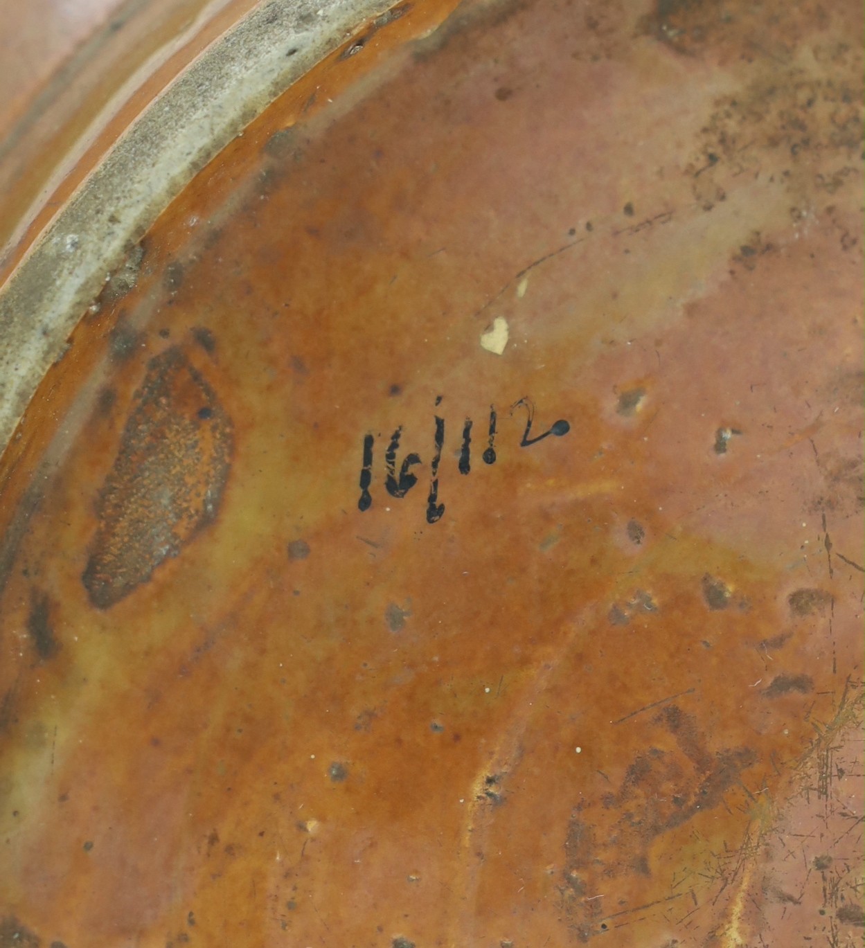 A Chinese Swatow slip-decorated brown ground dish, Zhangzhou kilns, early 17th century, 37cm diameter